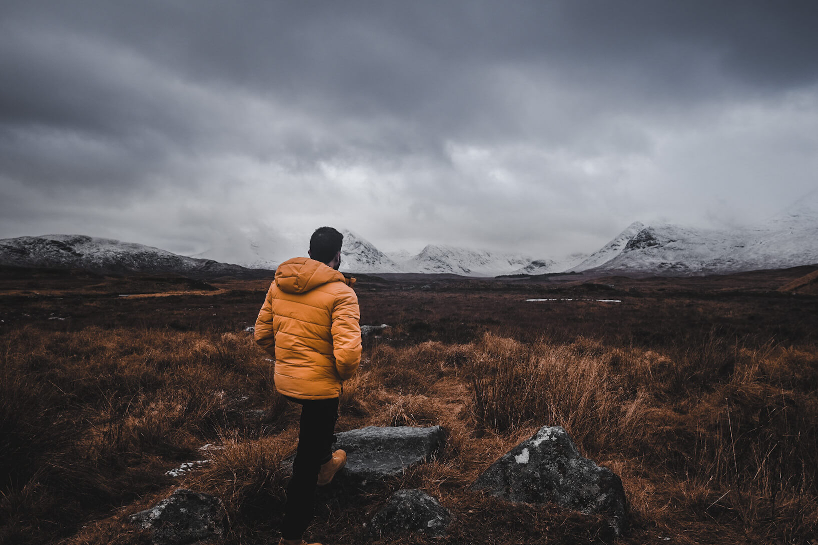 man looking on snowy Mountains in scotland