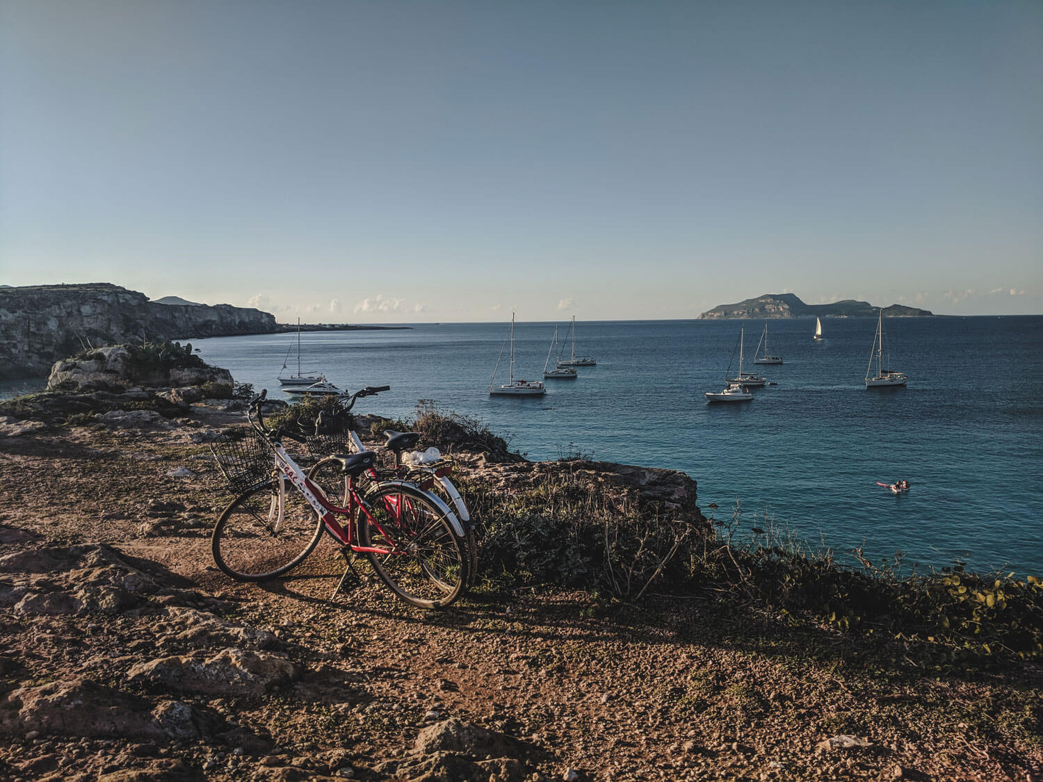 2 bikes on the cliffs over the ocean in favignana islandsicily