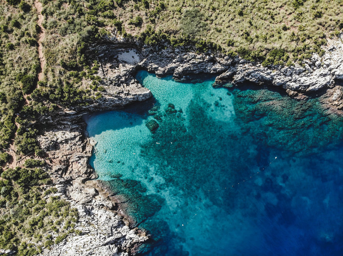 drone shot above zingaro nature reserve with beautiful scenery and water