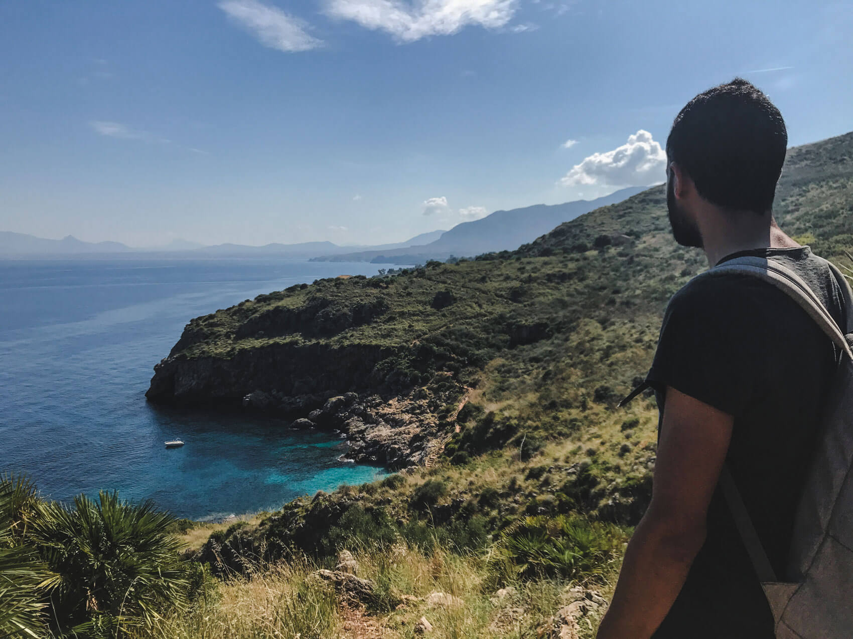 Man hiking in the zingaro nature reserve sicily