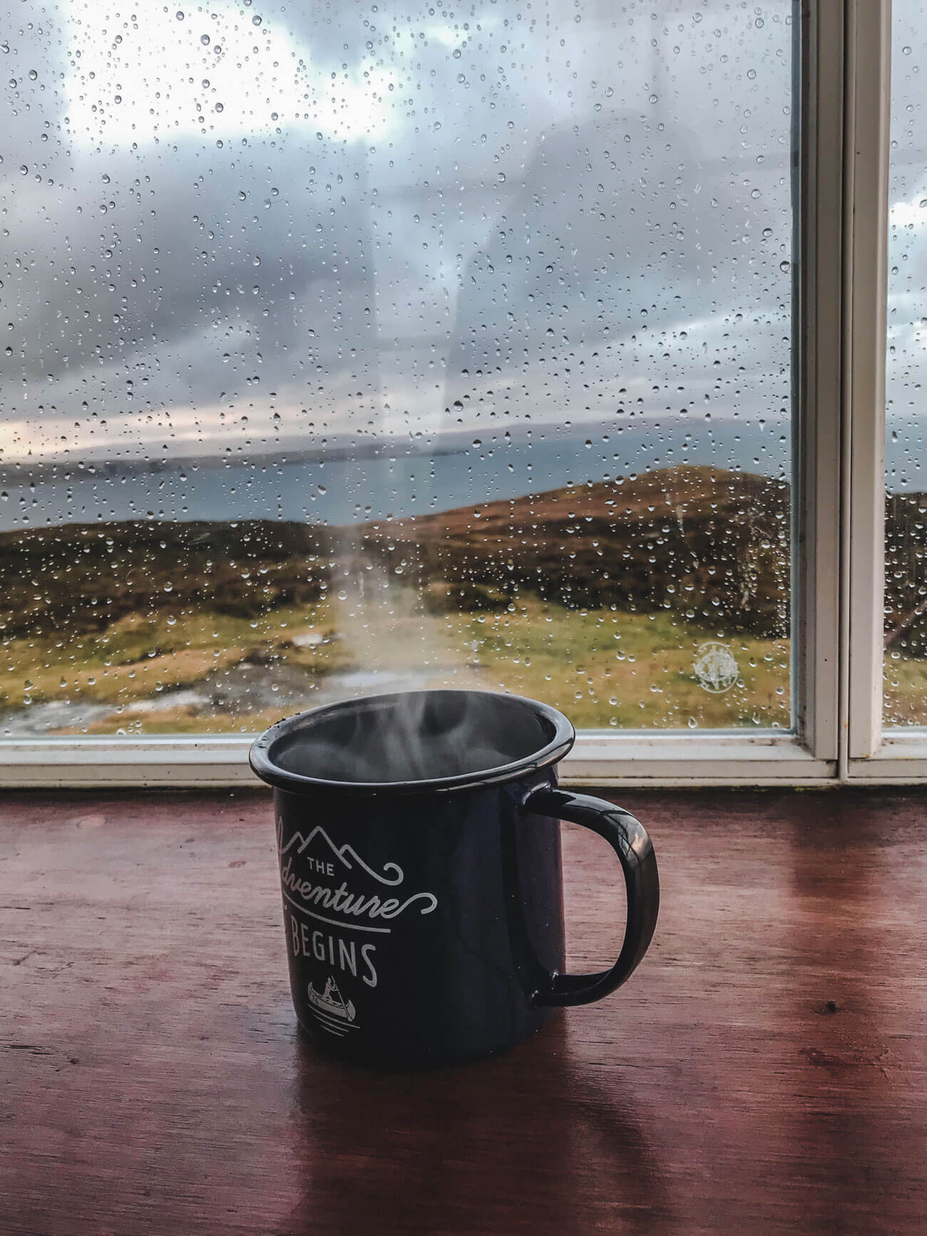 glass of coffe with rain outside in scotland