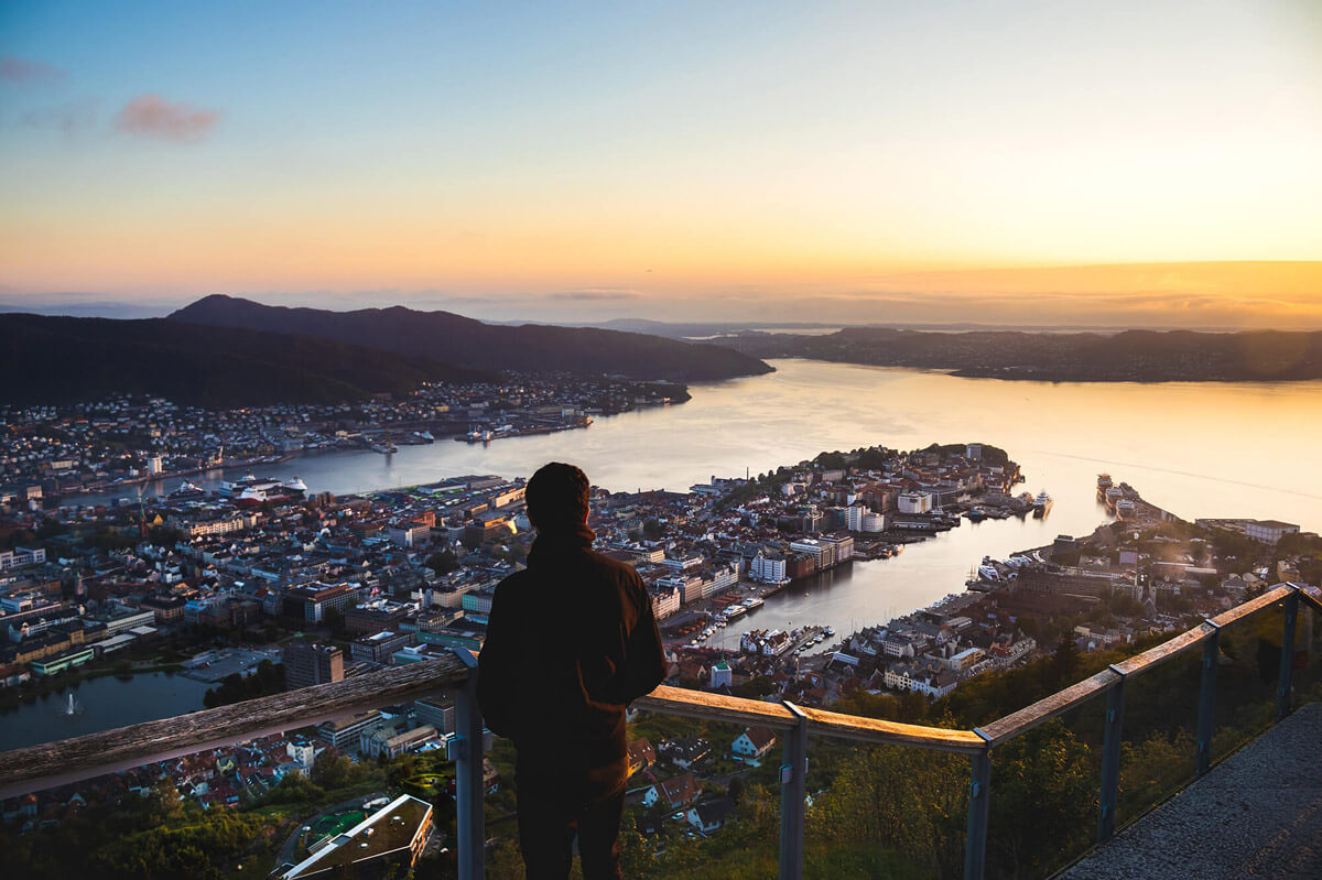 man standing on the view point of mount floyen and looking over bergen rom above